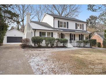 Two-story house with white exterior, landscaping, and attached garage at 5910 Grosner Pl, Charlotte, NC 28211