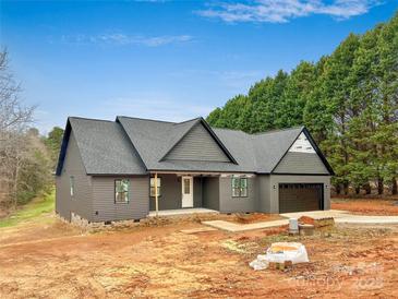 New gray house with gray roof and black garage door at 7287 Gabriel St, Sherrills Ford, NC 28673