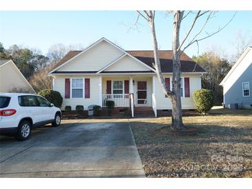 Cute yellow house with brown roof, small porch, and driveway at 2038 Mallard Creek Dr, Rock Hill, SC 29732