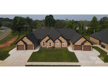 Beautiful duplex featuring brick facade, attached garages, and well-manicured lawn creating a welcoming curb appeal at 3341 48Th Ne Ave # 15A, Hickory, NC 28601