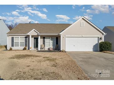 Beige house with a two-car garage and landscaping at 1630 Hardy Dr, Rock Hill, SC 29732