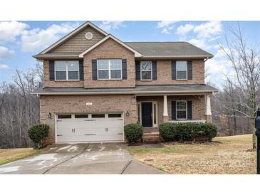 Two-story brick home with attached garage and landscaped lawn at 2548 Flintshire Ln, Gastonia, NC 28056