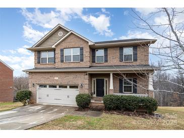 Two-story brick home with attached garage and manicured landscaping at 2548 Flintshire Ln, Gastonia, NC 28056