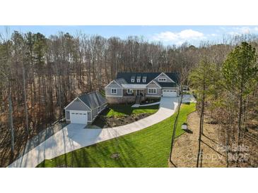 Stunning aerial view of a craftsman style home with a detached garage and landscaped yard at 324 Patternote Rd, Mooresville, NC 28117