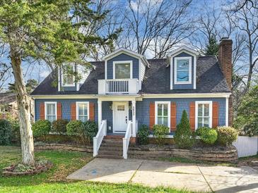 Charming two-story home with blue siding, orange shutters, and a landscaped yard at 3453 Selwyn Ave, Charlotte, NC 28209