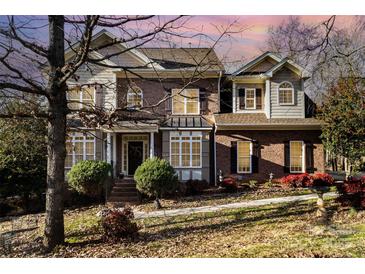 Brick two-story house with a large front yard and landscaping at 355 Sardis Rd N Alt Rd, Charlotte, NC 28270