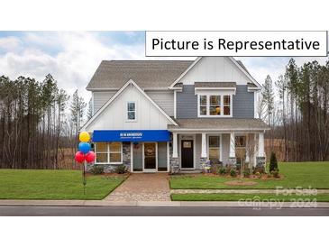 Two-story home with gray siding, white trim, and a welcoming front porch at 2019 Canvasback Way, Indian Trail, NC 28079