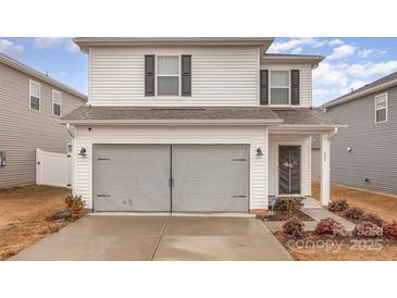 Two-story house with gray siding, double garage, and landscaping at 226 J.P. Dr, Albemarle, NC 28001