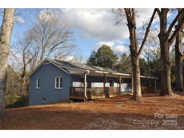 Ranch home with wraparound porch and mature trees at 733 Azalea Dr, Chester, SC 29706
