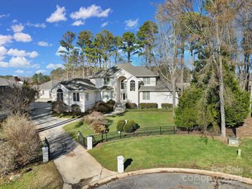 Elegant two-story home with a manicured front yard and a black iron fence at 115 Amelia Ln, Mooresville, NC 28117