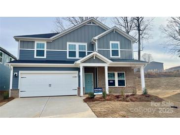 Two-story home with gray siding, brick accents, and a two-car garage at 115 Obadiah Ct, Mooresville, NC 28115