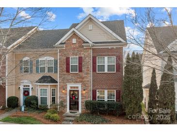 Brick front exterior of charming townhome with landscaping at 13823 Waverton Ln, Huntersville, NC 28078