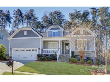 Two-story house with gray siding, stone accents, and a front porch at 17627 Caddy Ct, Charlotte, NC 28278