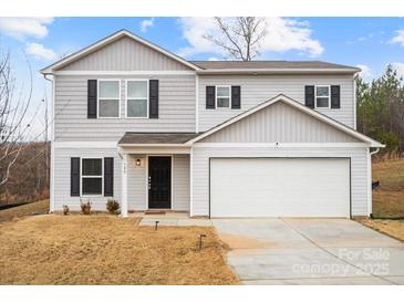 Two-story house with gray siding, a two-car garage, and a well-maintained lawn at 180 Four Andrews Dr, Harmony, NC 28634