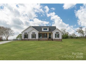 Inviting single-Gathering home with white siding and black shutters, complemented by a lush green lawn at 2657 Polo Ln, Maiden, NC 28650