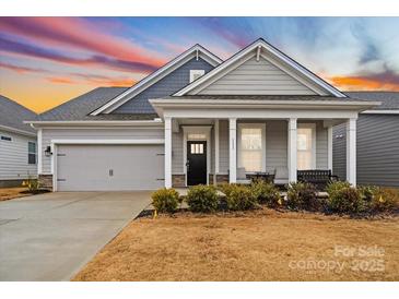 Gray siding one-story house with front porch and two-car garage at 111 N Shayna Rd, Troutman, NC 28166