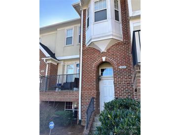 Brick front exterior of townhome with entrance and small balcony at 14243 Richmond Park Ave, Charlotte, NC 28277