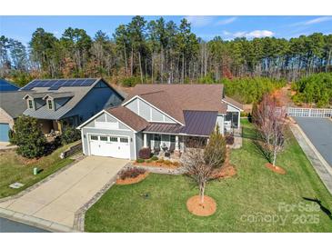 Single-story home with a landscaped yard and two-car garage at 7145 Hanging Rock Ct, Denver, NC 28037