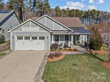 Gray craftsman style home with a metal roof and welcoming front porch at 7145 Hanging Rock Ct, Denver, NC 28037