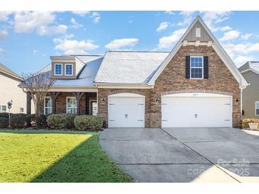 Beautiful two-story home with stone accents and a three-car garage at 1057 Princeton Dr, Indian Land, SC 29707