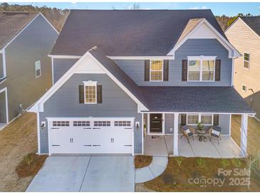 Two-story gray house with white garage door, porch, and landscaping at 1844 Giana Ln, Monroe, NC 28112