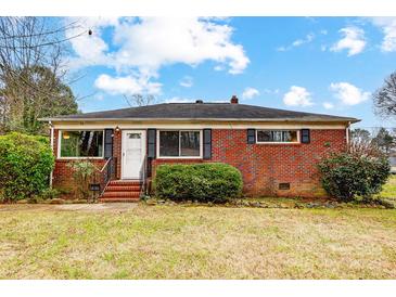 Brick ranch house with front yard, steps and shrubs at 2504 Juniper Dr, Charlotte, NC 28269