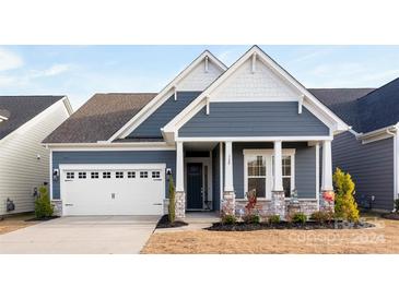 Gray-blue charming craftsman home with white garage door and stone accents at 320 Northgate Blvd, Indian Trail, NC 28079