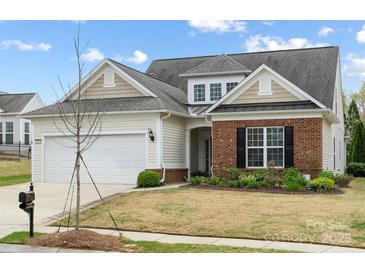 Charming home featuring a two-car garage and manicured lawn at 5981 Bison Ct, Fort Mill, SC 29707