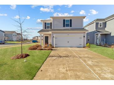 Charming two-story home with a well-maintained lawn and inviting curb appeal on a sunny day at 1124 Jeffery Dean Ct, Albemarle, NC 28001