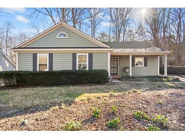 Charming ranch home with gray siding, shutters, and a covered porch at 1511 Longbrook Dr, Charlotte, NC 28270