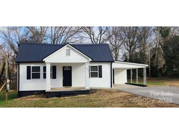 Charming white house with black roof and a covered carport at 502 North Dr, Cherryville, NC 28021