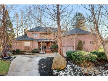 Brick home with large driveway and landscaping at 19216 Wildcat Trl, Davidson, NC 28036