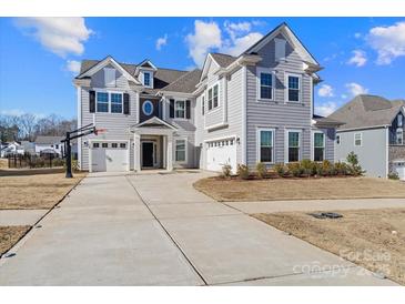 Two-story house with gray siding, three-car garage, and a basketball goal at 298 Bouchard Dr, Waxhaw, NC 28173