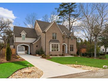 Charming brick home with attached garage, landscaped lawn, and driveway, perfect for suburban living at 336 Anthony Cir, Charlotte, NC 28211