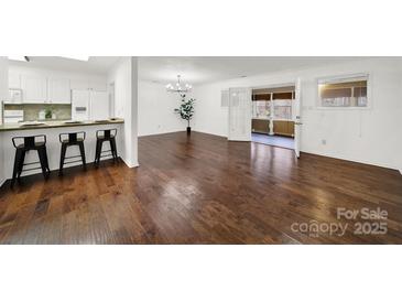 Spacious dining room with hardwood floors and access to a sunroom at 114 Ashbrook Dr, Fort Mill, SC 29715