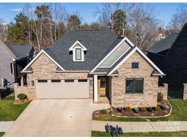 Aerial view of a charming craftsman style home with a two-car garage and manicured landscaping at 1422 Spring Ridge Ln, Denver, NC 28037