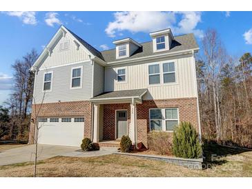 Two-story brick home with gray siding, white garage door, and landscaping at 356 Nantucket Way, Rock Hill, SC 29732