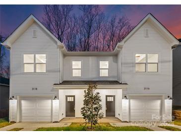 Modern two-unit building with white siding, attached garages, and landscaping at 3118 Amay James Ave, Charlotte, NC 28208