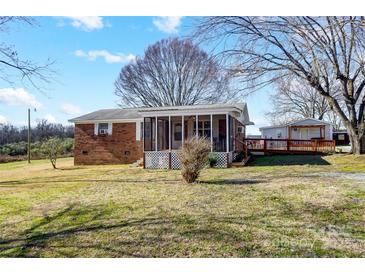 Brick ranch house with screened porch and large backyard at 3524 Lancaster Hwy, Monroe, NC 28112