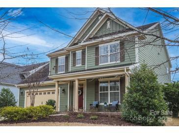 Charming two-story home with a welcoming front porch and meticulously manicured landscaping, enhancing its curb appeal at 17611 Austins Creek Dr, Charlotte, NC 28278