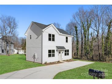 Two-story house with white siding, a driveway, and a grassy yard at 1817 Vista Ter, Statesville, NC 28677