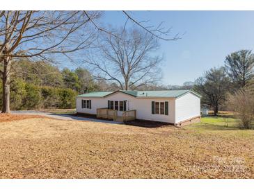 White single-wide mobile home with green metal roof; large yard at 2379 Justin Dr, York, SC 29745
