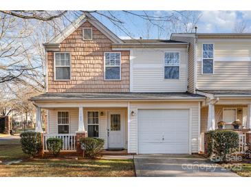 Two-story townhome with neutral siding, attached garage, and small front porch at 5927 Pisgah Way, Charlotte, NC 28217
