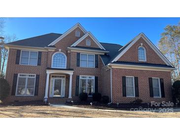 Brick front two-story house with a large yard at 2306 Cota Ct, Charlotte, NC 28262