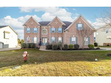 Brick two-story house with landscaping and a front yard at 1009 Murandy Ln, Matthews, NC 28104