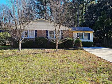 Ranch home with brick facade and mature trees at 5107 Auburndale Rd, Charlotte, NC 28205