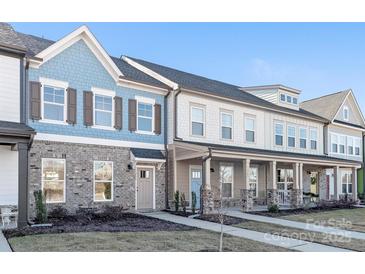 Three-story townhouses with brick and siding exteriors, front porches, and landscaping at 1066 Riverwalk Pkwy, Rock Hill, SC 29730