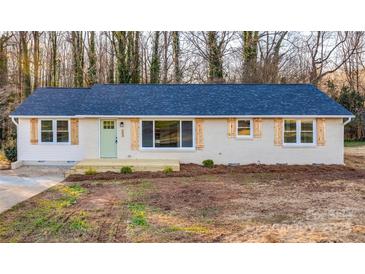 Newly renovated ranch home featuring a light brick exterior, new roof, and updated landscaping at 145 Burton Hills Cir, Gastonia, NC 28054