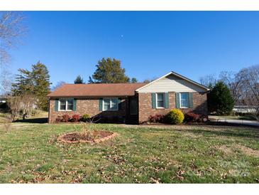 Brick ranch house with landscaped yard and driveway at 1544 Daybreak Ridge Rd, Kannapolis, NC 28081