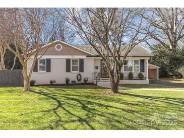 Charming ranch home with brick facade and landscaped lawn at 1814 Archdale Dr, Charlotte, NC 28210